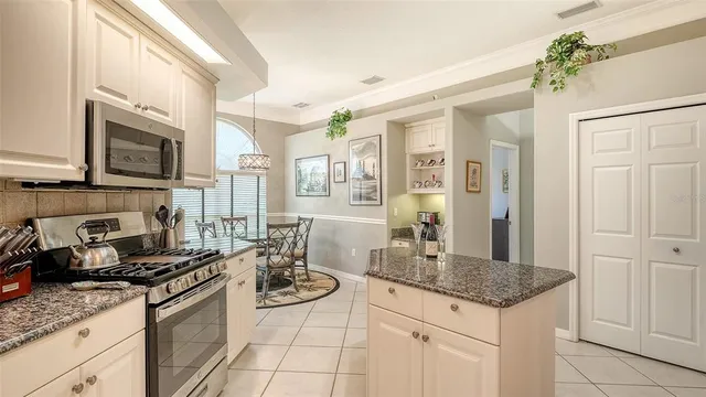 a kitchen with stainless steel appliances granite countertop a sink stove and cabinets
