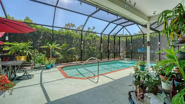 a patio with a table and chairs under an umbrella