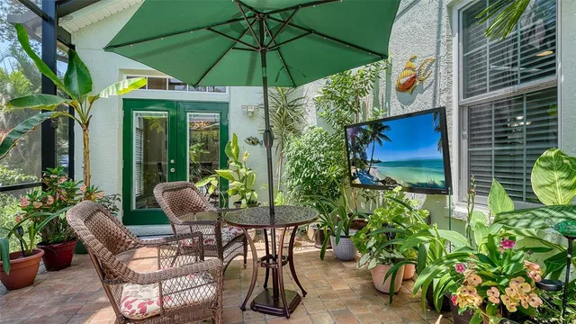 a patio with a table and chairs under an umbrella