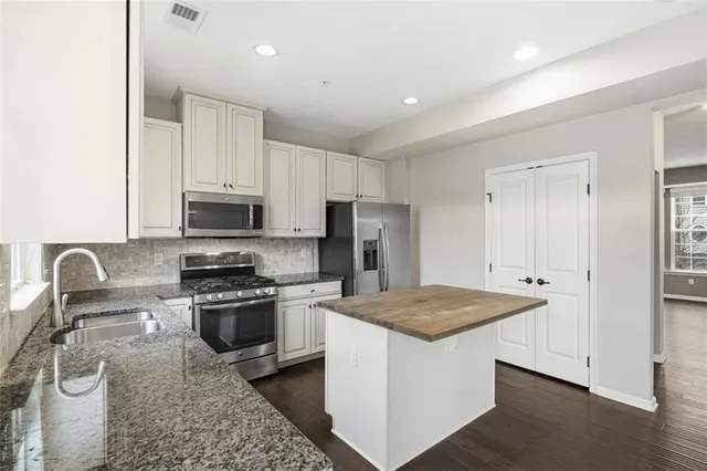 a view of an empty room and a bathroom