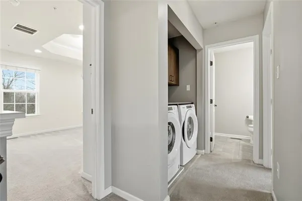 a view of a storage & utility room with a washer dryer
