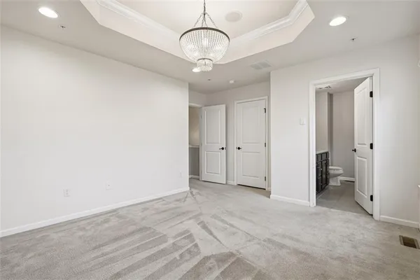 a view of an empty room and a bathroom