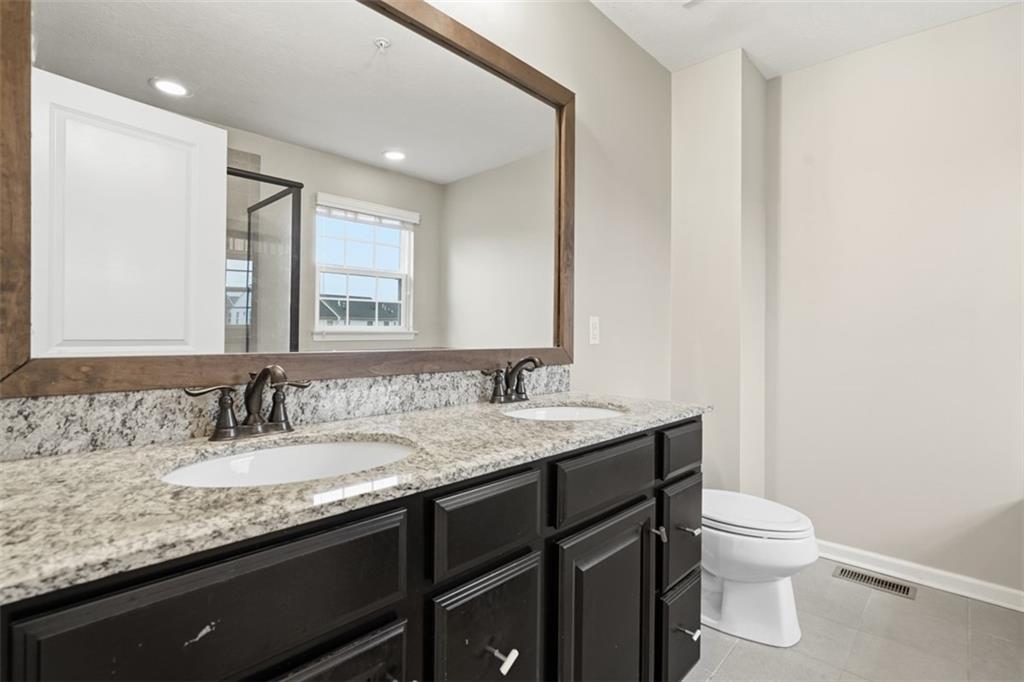 1204 Pointe View Drive Mars, PA 16046 - Photo 24 of 37 a bathroom with a granite countertop sink a toilet and a mirror