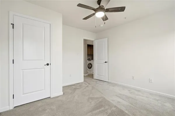 an empty room with closet and windows