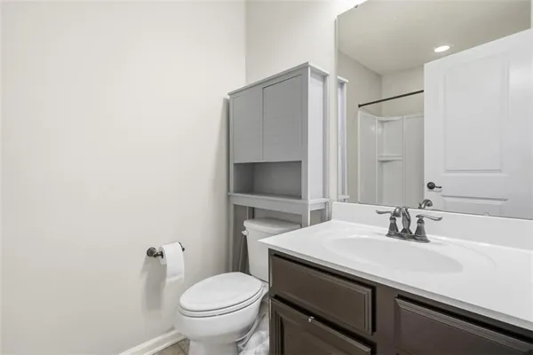 a bathroom with a sink toilet and mirror