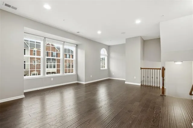 a view of wooden floor and windows in a room