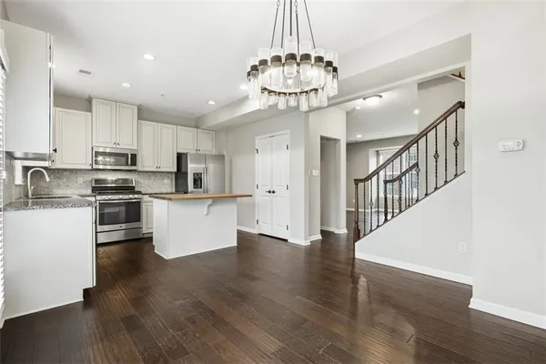 a view of kitchen with microwave and cabinets