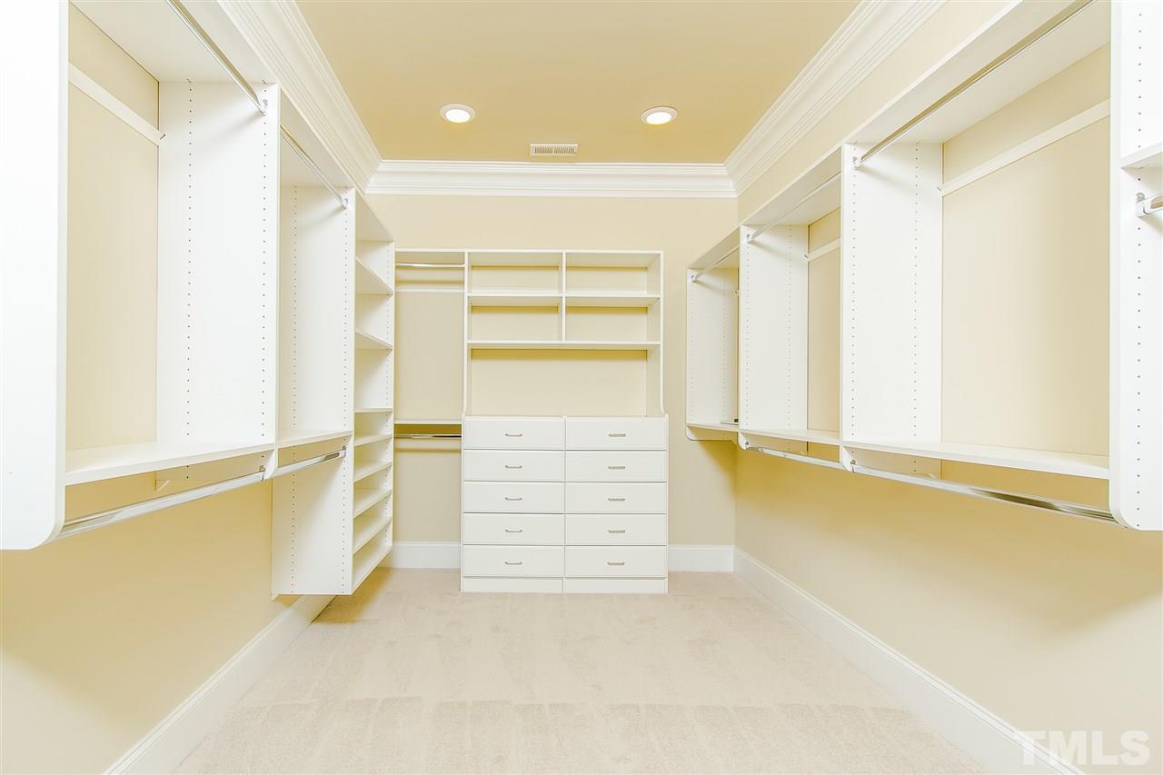 319 Perry Street Raleigh, NC 27608 - Photo 13 of 25 a view of walk in closet with empty racks