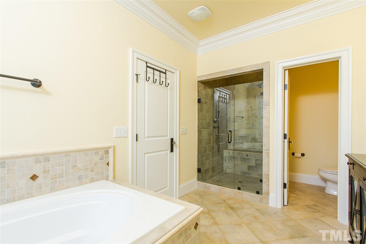 319 Perry Street Raleigh, NC 27608 - Photo 15 of 25 a spacious bathroom with a shower and a toilet