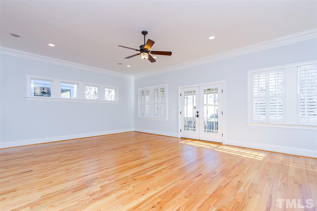 319 Perry Street Raleigh, NC 27608 - Photo 5 of 25 a view of an empty room with a window and wooden floor