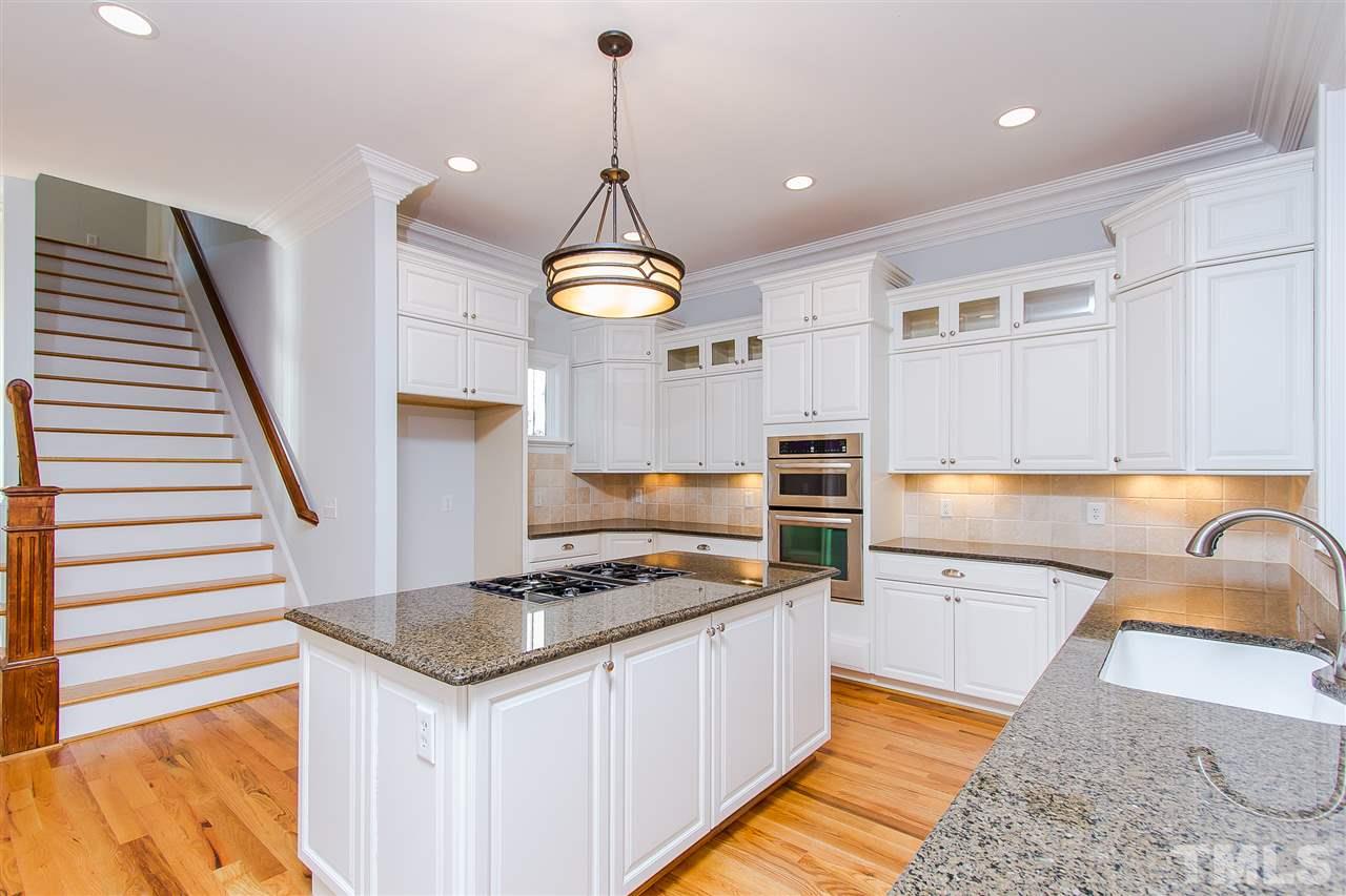 319 Perry Street Raleigh, NC 27608 - Photo 8 of 25 a kitchen that has a lot of cabinets in it