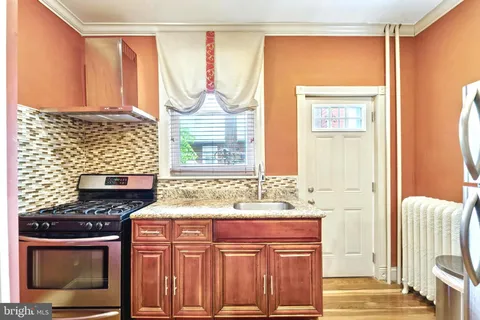 a bathroom with a sink a vanity and a large mirror