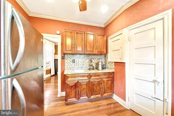 a view of a kitchen with wooden floor and a window