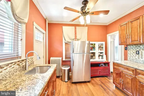 a kitchen with granite countertop a sink and a window