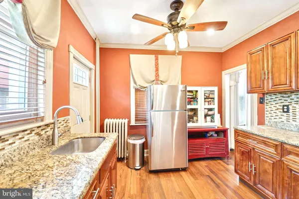 a kitchen with granite countertop a sink and a window