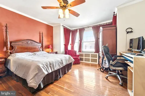 a bed room with a bed and a desk