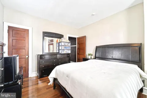 a bedroom with a bed and a television