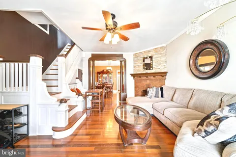 a living room with furniture and fireplace
