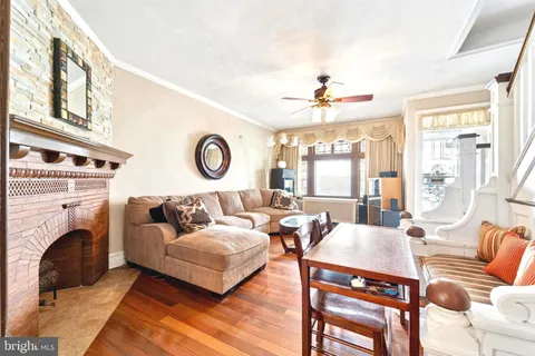 a living room with furniture a fireplace and a large window