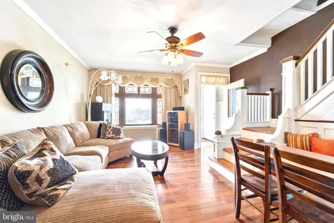 a living room with furniture a table and a large window