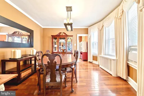 a view of a a dining room with furniture window and wooden floor