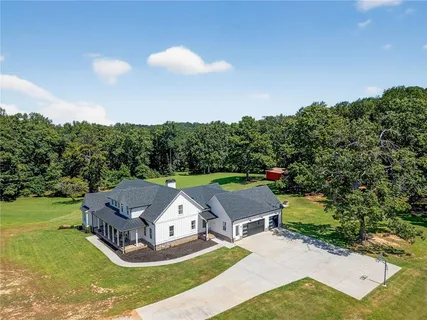 an aerial view of a house with garden space and street view