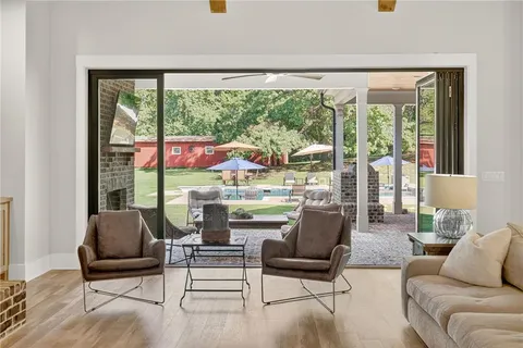 a kitchen with stainless steel appliances kitchen island granite countertop a dining table chairs and granite counter tops