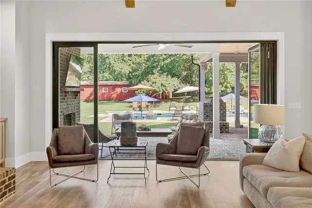 a kitchen with stainless steel appliances kitchen island granite countertop a dining table chairs and granite counter tops