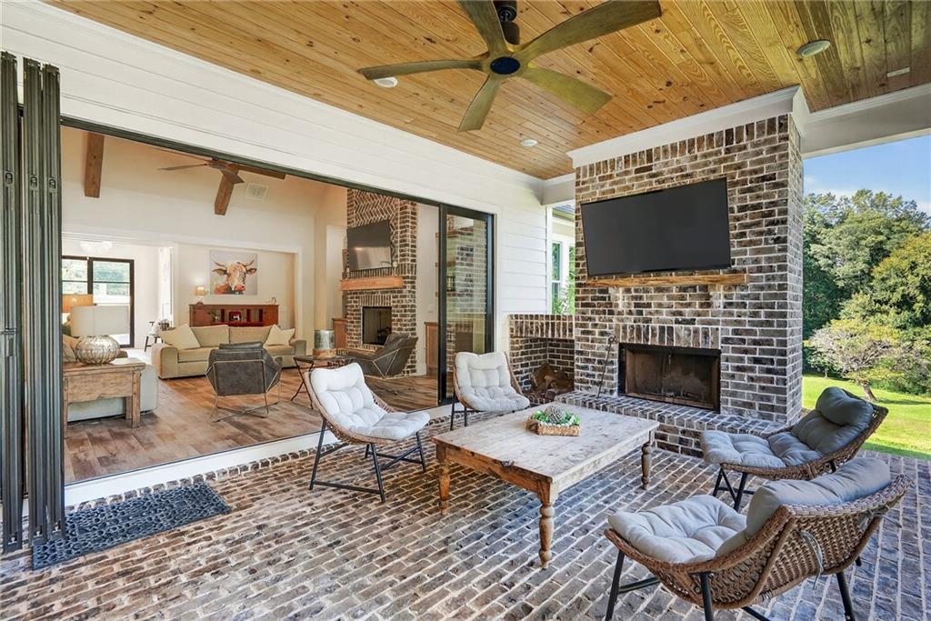 4621 Stanley Road Flowery Branch, GA 30542 - Photo 14 of 65 a living room with furniture a fireplace and a table