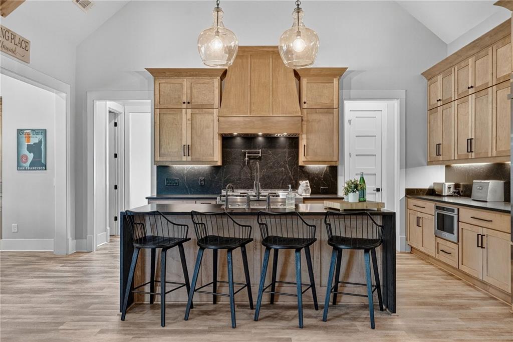 4621 Stanley Road Flowery Branch, GA 30542 - Photo 18 of 65 a kitchen with stainless steel appliances kitchen island granite countertop a dining table chairs and granite counter tops