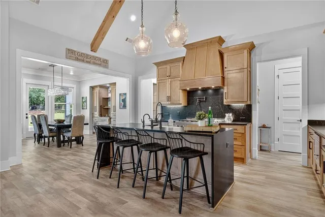 a spacious bathroom with a granite countertop sink a mirror a toilet and a shower