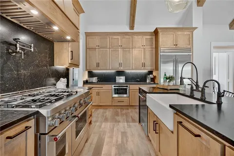 a view of a room with wooden floor and sink