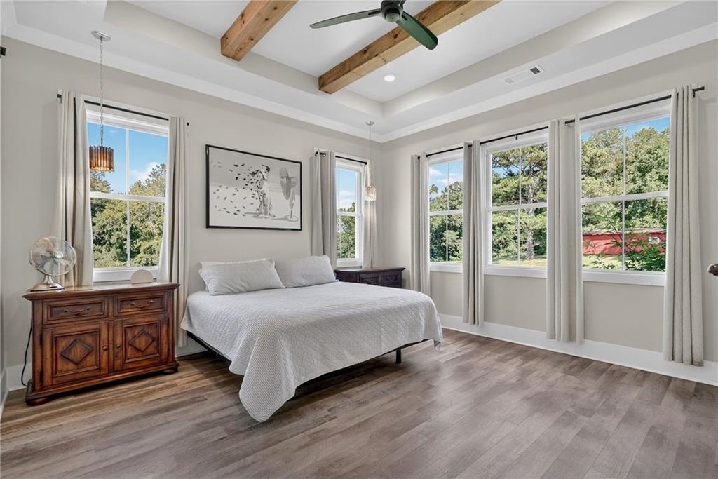 4621 Stanley Road Flowery Branch, GA 30542 - Photo 24 of 65 a spacious bedroom with a large bed and a window