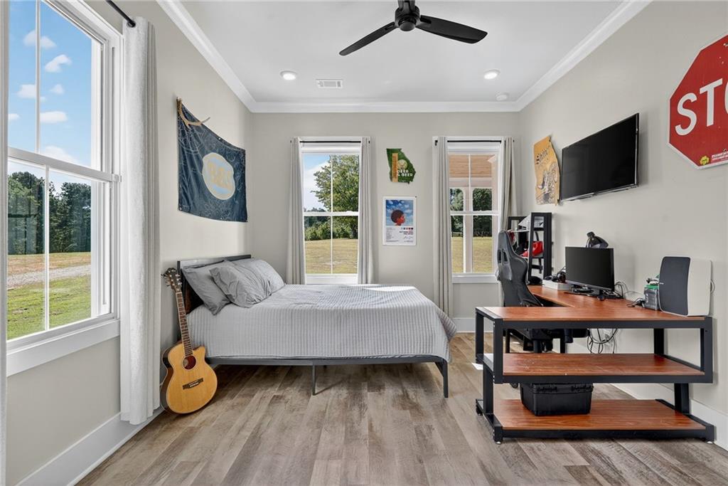 4621 Stanley Road Flowery Branch, GA 30542 - Photo 29 of 65 a living room with furniture and a flat screen tv