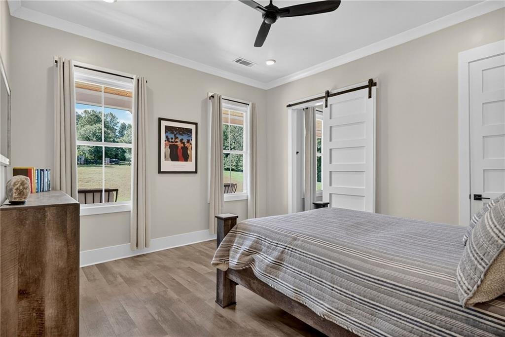 4621 Stanley Road Flowery Branch, GA 30542 - Photo 32 of 65 a bedroom with a bed dresser and a window