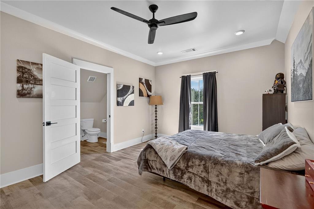 4621 Stanley Road Flowery Branch, GA 30542 - Photo 35 of 65 a bedroom with a bed and a walk in closet