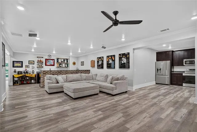 an aerial view of a house with swimming pool and large tree