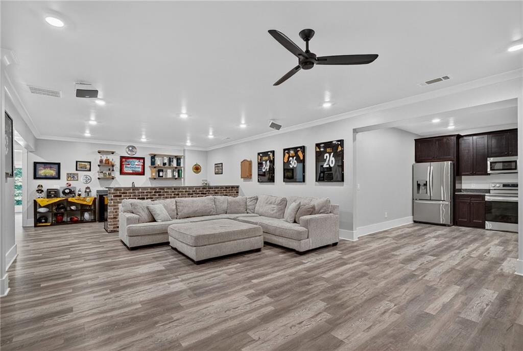 4621 Stanley Road Flowery Branch, GA 30542 - Photo 38 of 65 a living room with furniture and kitchen view