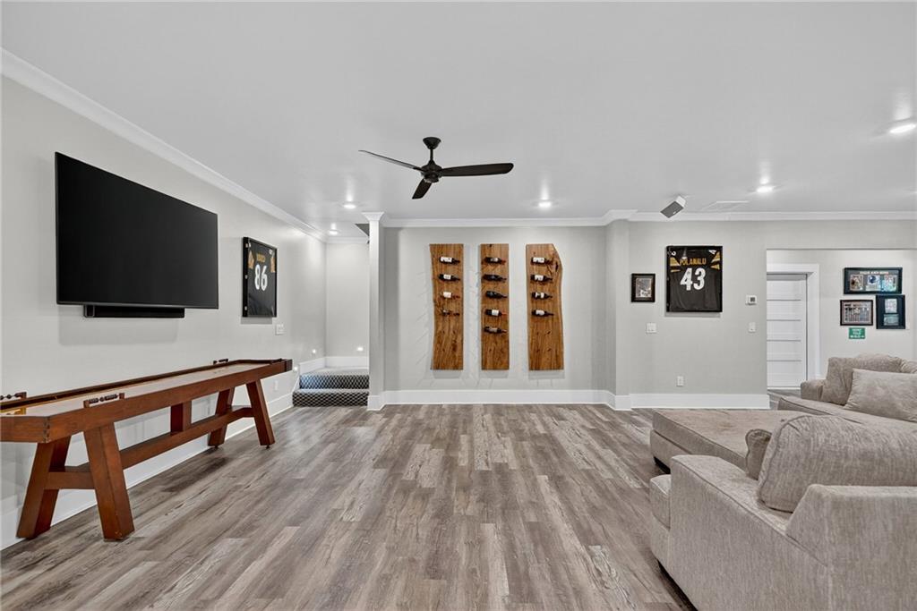4621 Stanley Road Flowery Branch, GA 30542 - Photo 39 of 65 a living room with furniture and a flat screen tv
