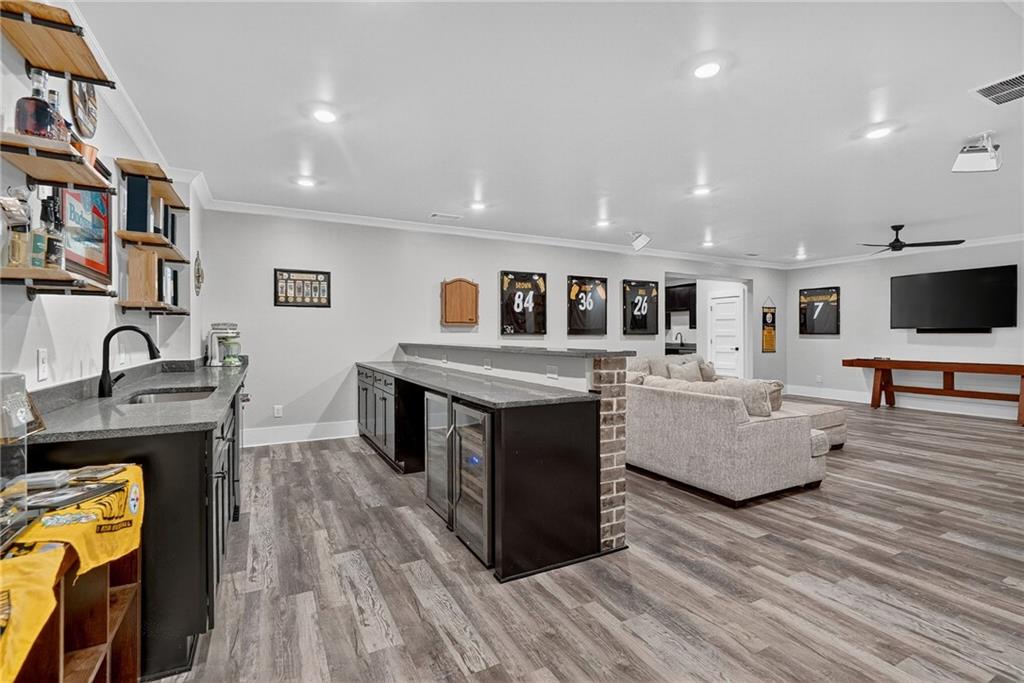 4621 Stanley Road Flowery Branch, GA 30542 - Photo 41 of 65 a living room with furniture and a flat screen tv