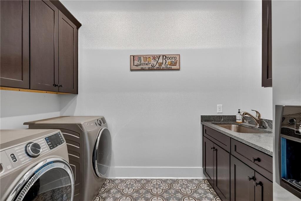 4621 Stanley Road Flowery Branch, GA 30542 - Photo 46 of 65 a utility room with sink dryer and washer