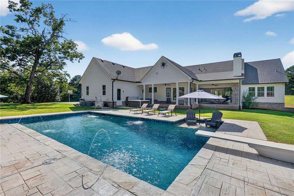 4621 Stanley Road Flowery Branch, GA 30542 - Photo 47 of 65 a swimming pool view with a seating space and a garden view