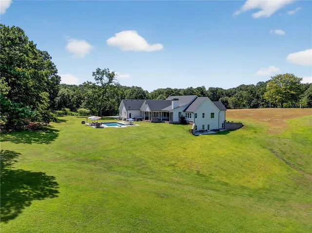 a front view of a house with a yard table and chairs