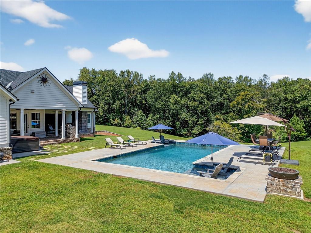 4621 Stanley Road Flowery Branch, GA 30542 - Photo 53 of 65 a view of a house with swimming pool and sitting area