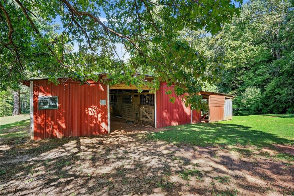 4621 Stanley Road Flowery Branch, GA 30542 - Photo 57 of 65 a view of a backyard with a barn
