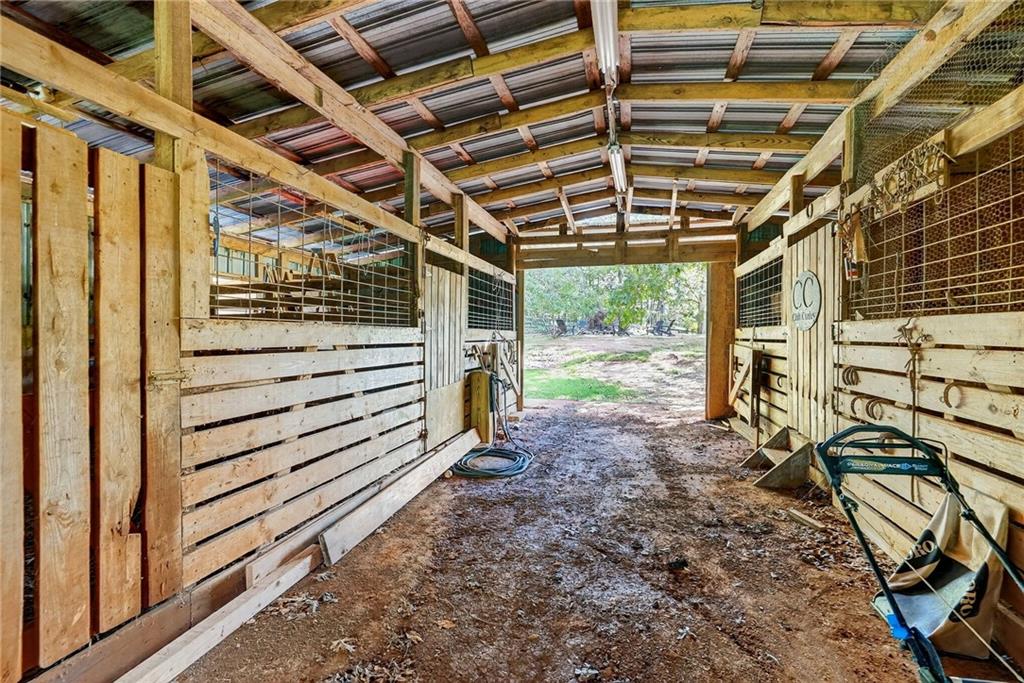 4621 Stanley Road Flowery Branch, GA 30542 - Photo 58 of 65 a view of a garage with wooden floor