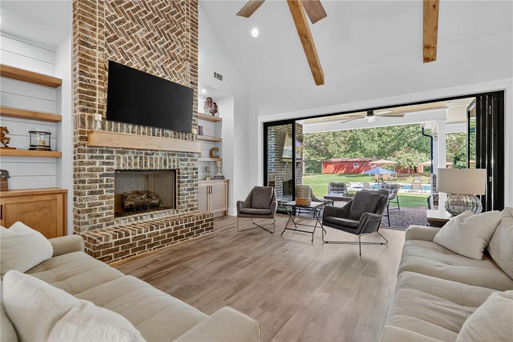 4621 Stanley Road Flowery Branch, GA 30542 - Photo 8 of 65 a living room with furniture a fireplace and a flat screen tv