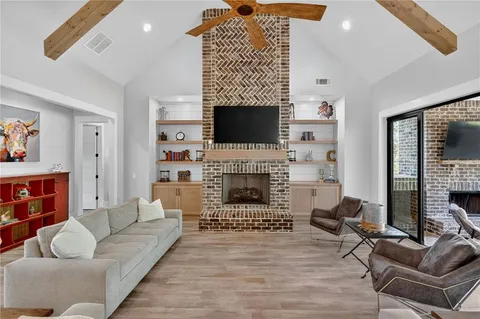 a living room with furniture a fireplace and a table