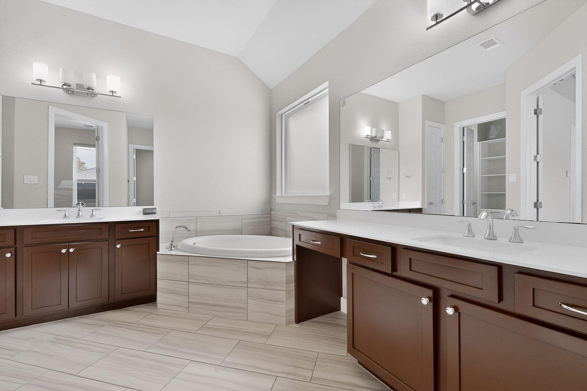 3137 Catalina Ranch Road Leander, TX 78641 - Photo 9 of 21 Full bathroom featuring vaulted ceiling, a garden tub, and two vanities