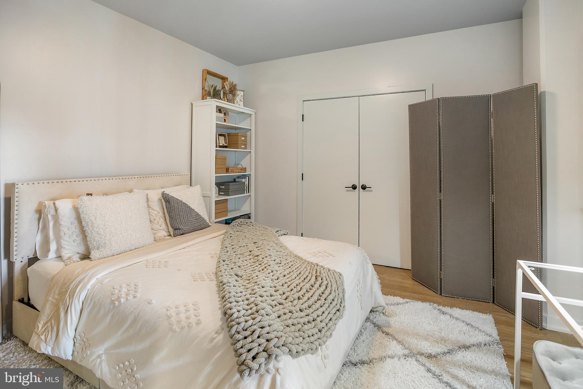 1625 Eckington Place Northeast, Unit 421 Washington, DC 20002 - Photo 17 of 40 a bed room with a bed and a closet